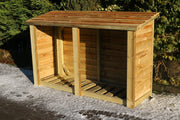 Wooden outdoor storage shed with a slanted roof, surrounded by greenery.
