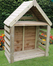 Wooden playhouse on a grassy area with flowers and bushes in the background